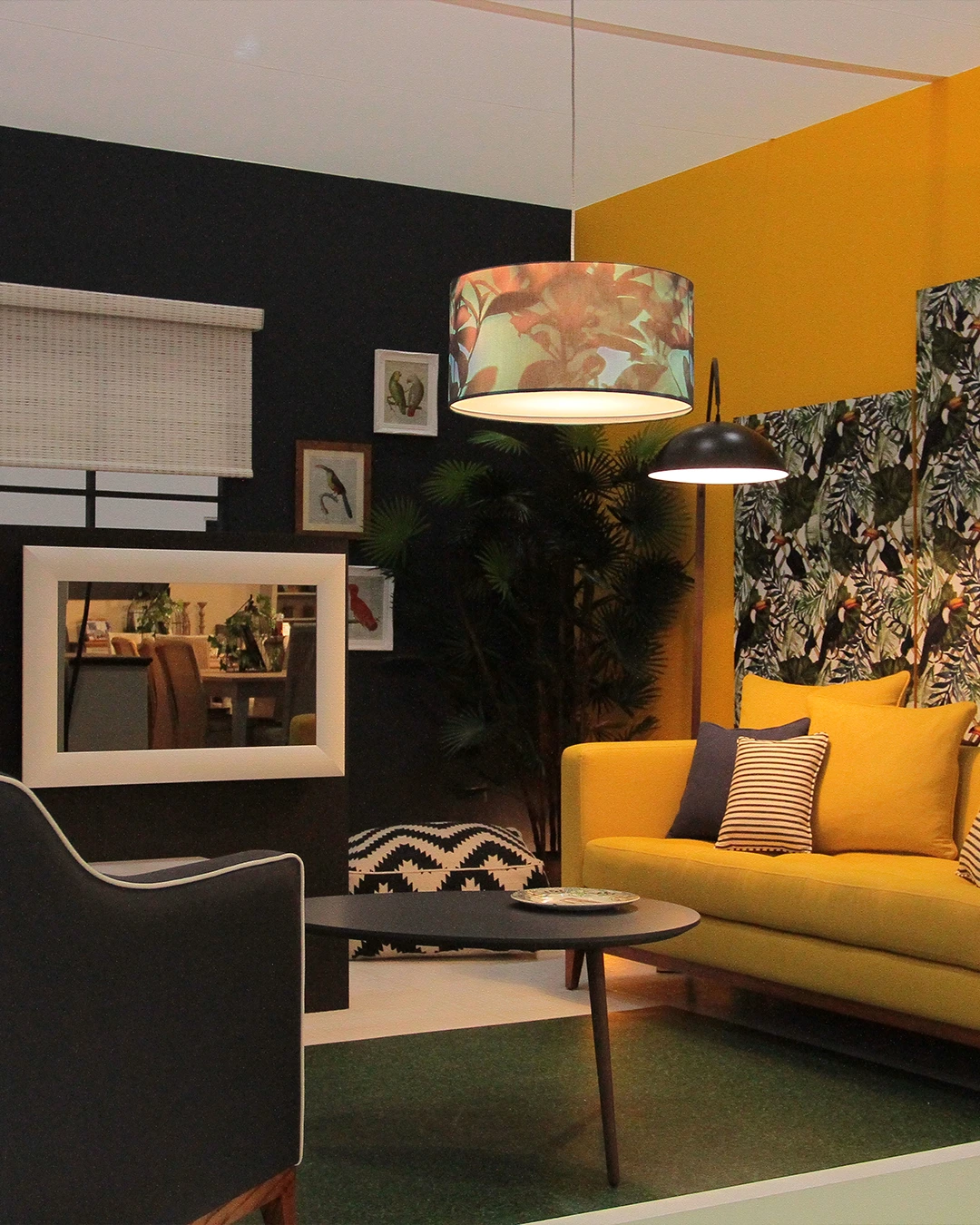 Exhibition living space with contrasting yellow and black walls and modern furniture