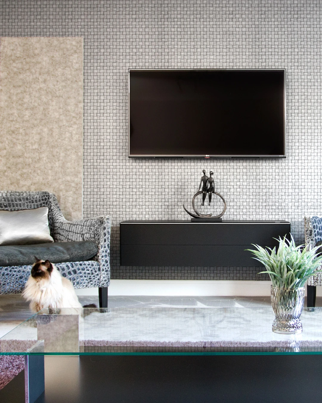 Contemporary townhouse living area with wall-mounted TV and metallic detailing