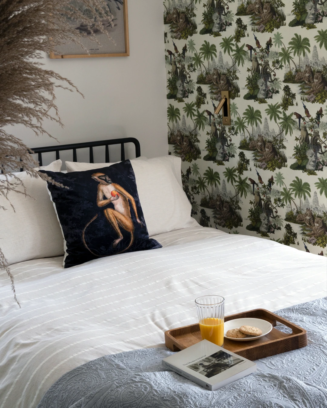 Maximalist-inspired master bedroom with statement wallpaper and decorative styling